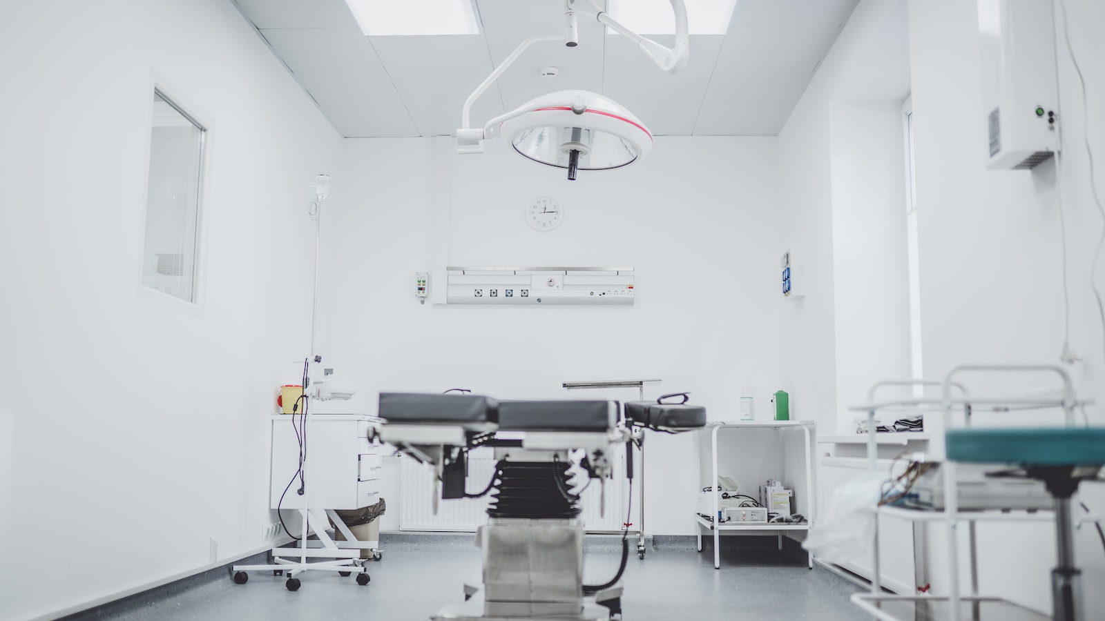 black and white hospital bed in the middle of interior building