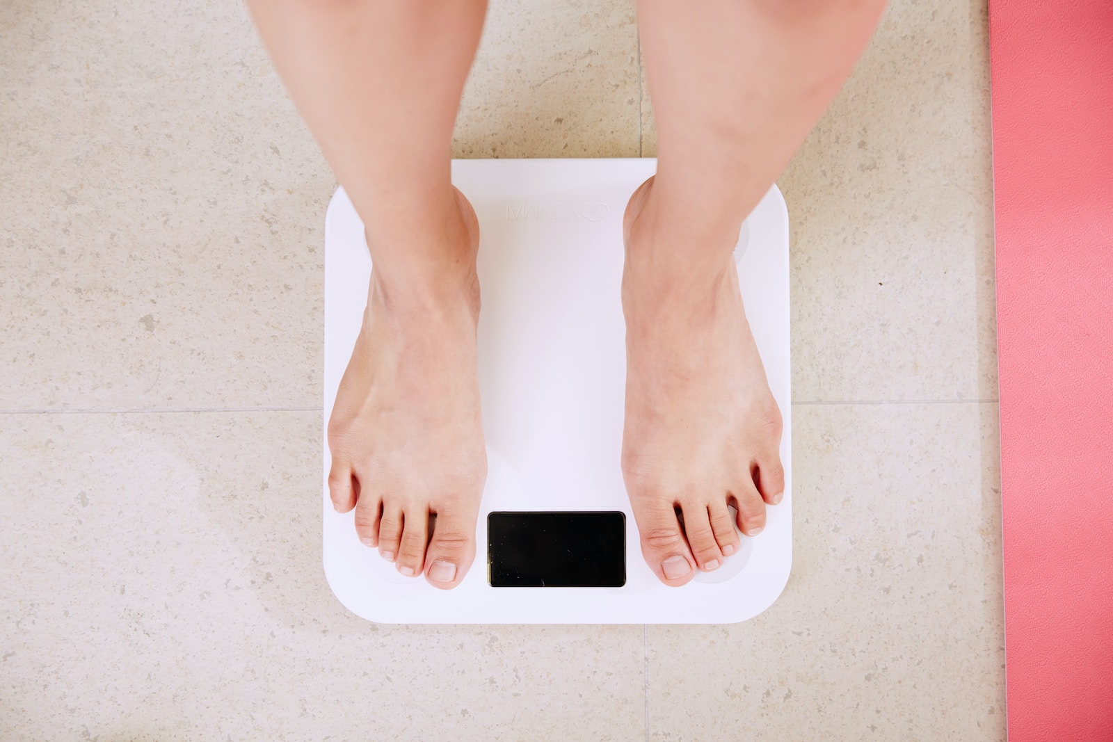 person standing on bathroom scale