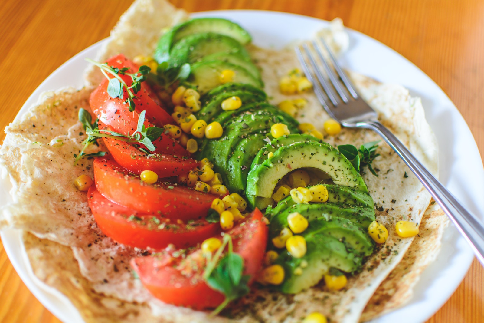 Sliced Tomato and Avocado on Plate