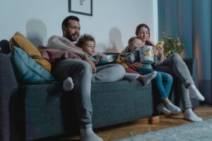 Family Sitting on a Sofa Eating Popcorn