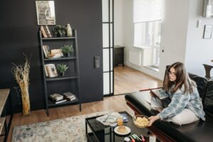 Woman Sitting on a Black Sofa