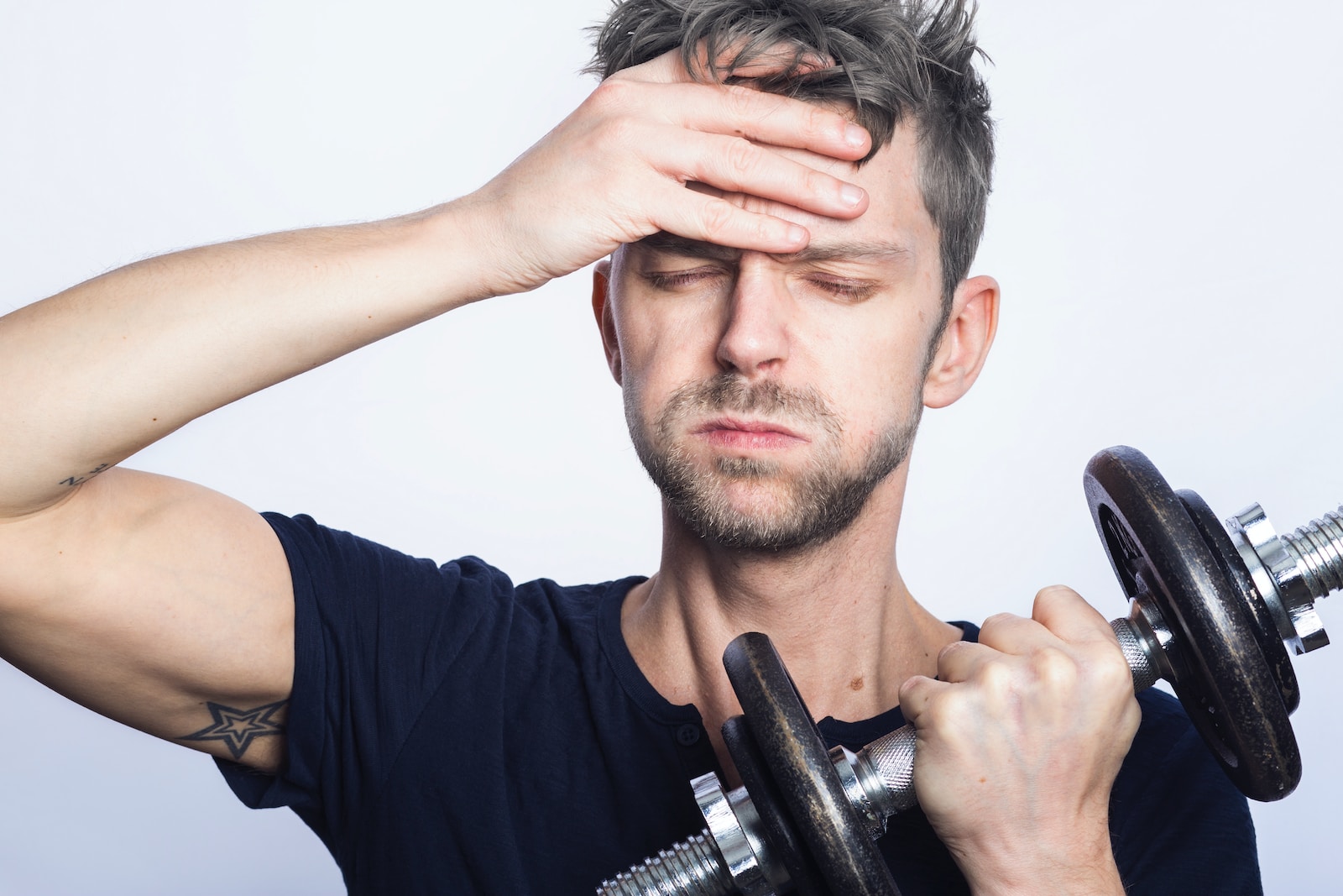 man holding black dumbbell