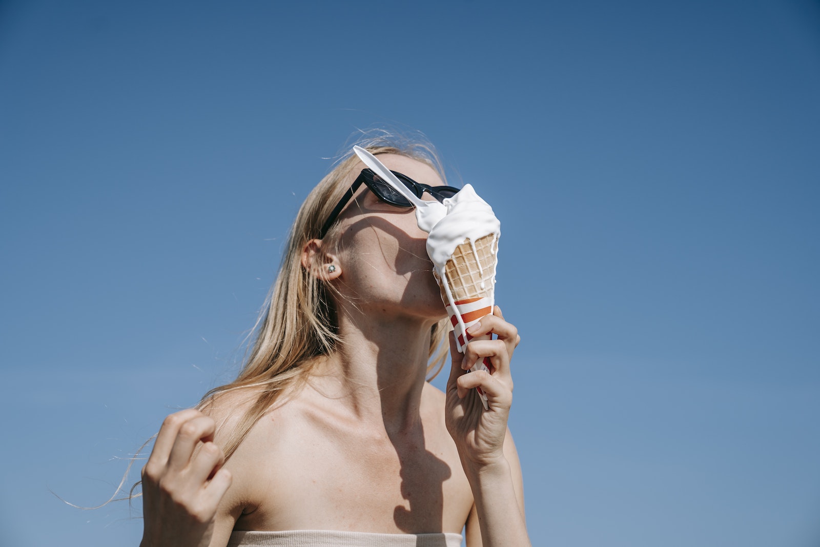 Woman Eating Melting Ice Cream