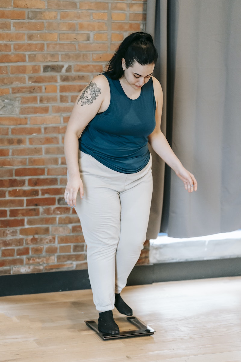 woman standing on weighing scales