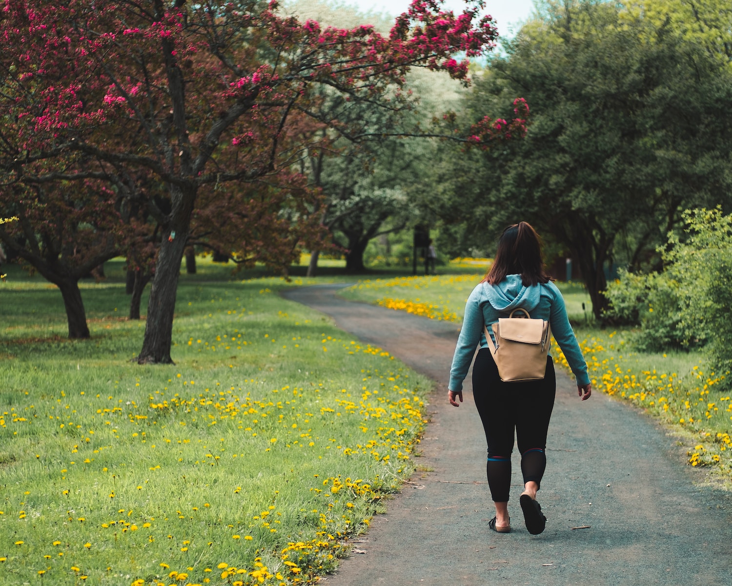 woman walking on grass field