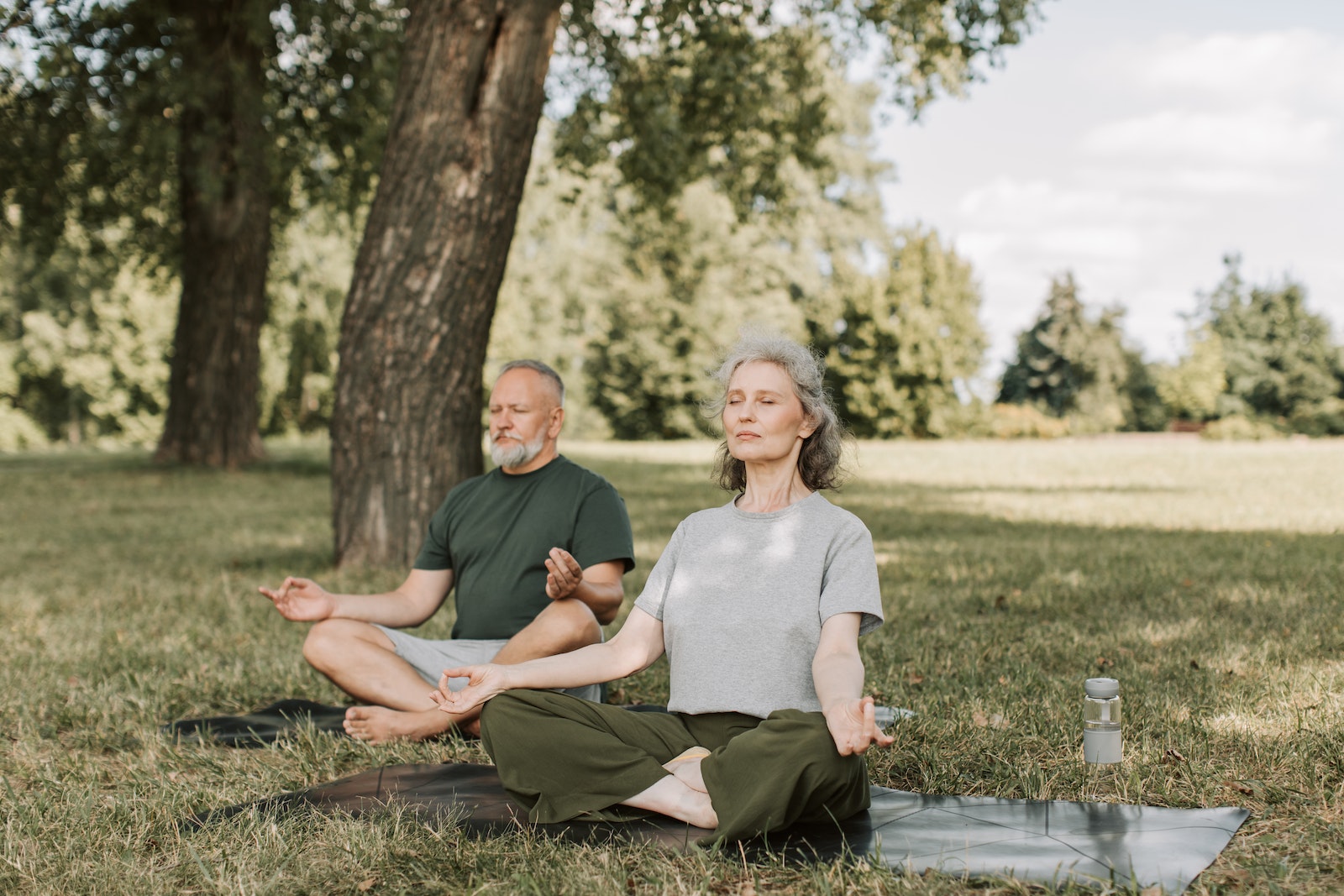 Elderly Couple Meditating in the Park