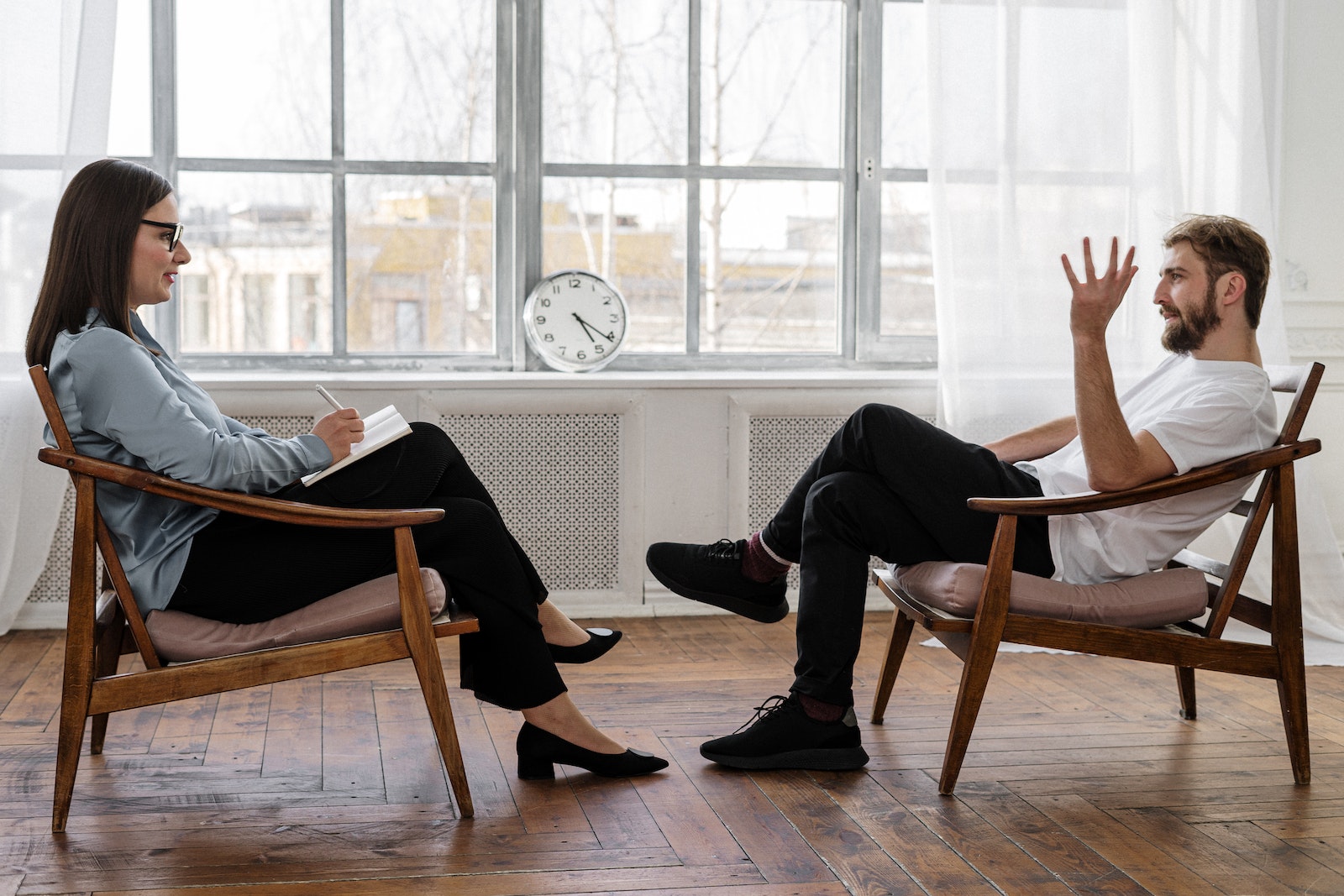 man and woman sitting on a chair