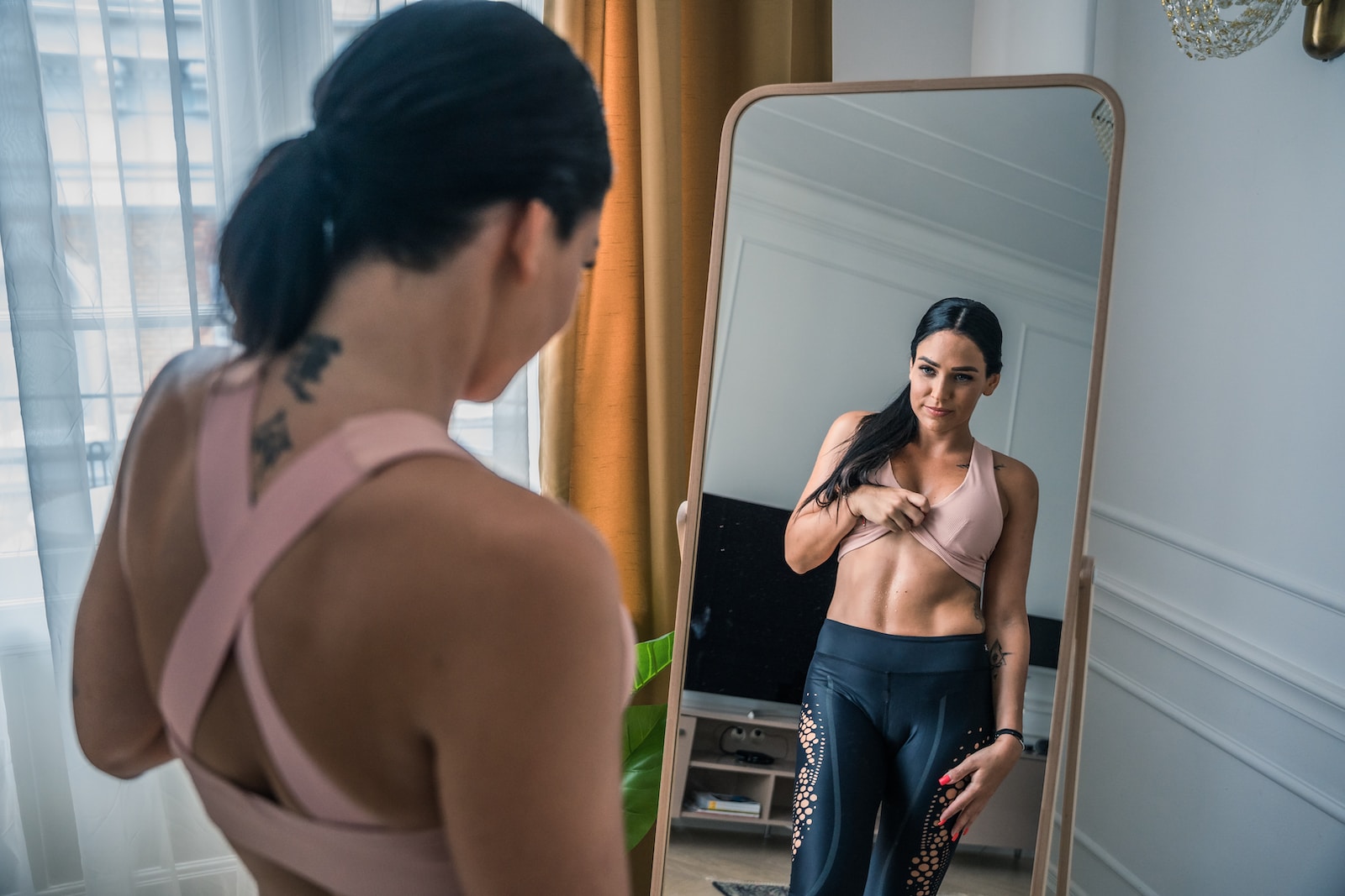 woman looking herself to mirror