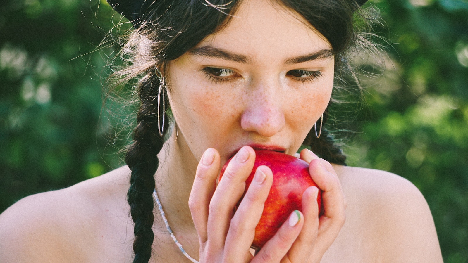 woman holding red apple fruit