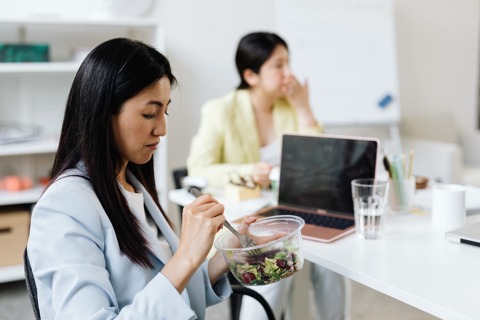 Woman in a Blue Blazer Eating Salad