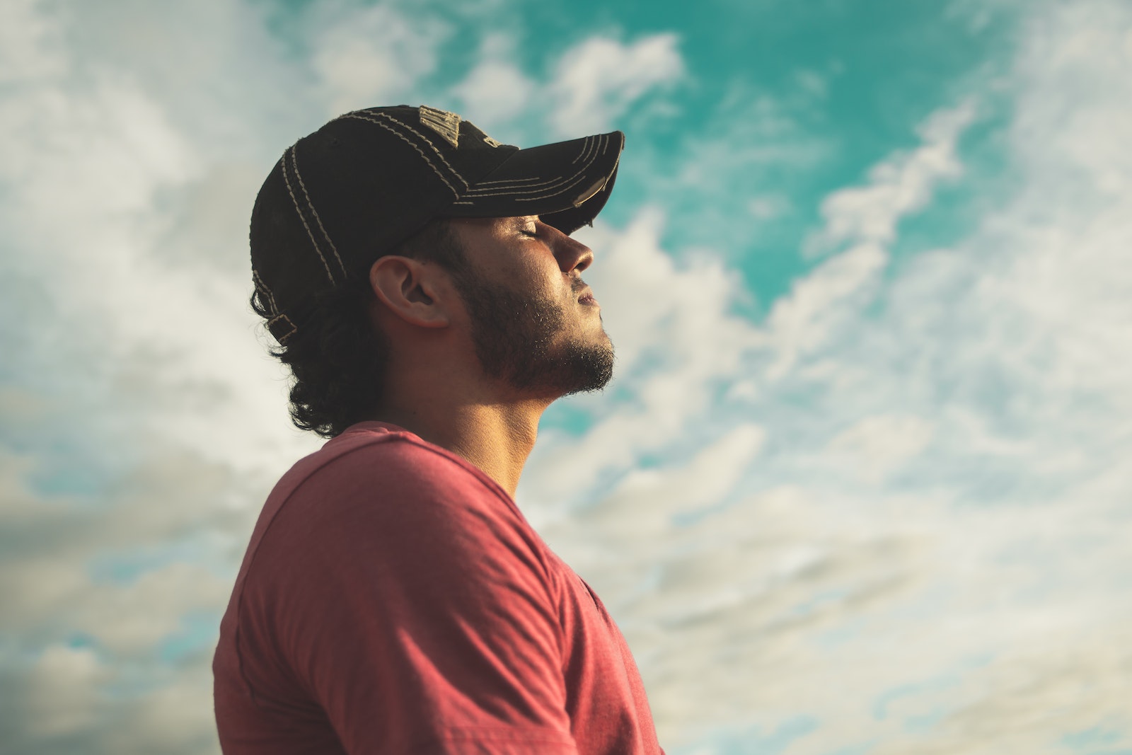 Man Closed Eyes Under Cloudy Sky