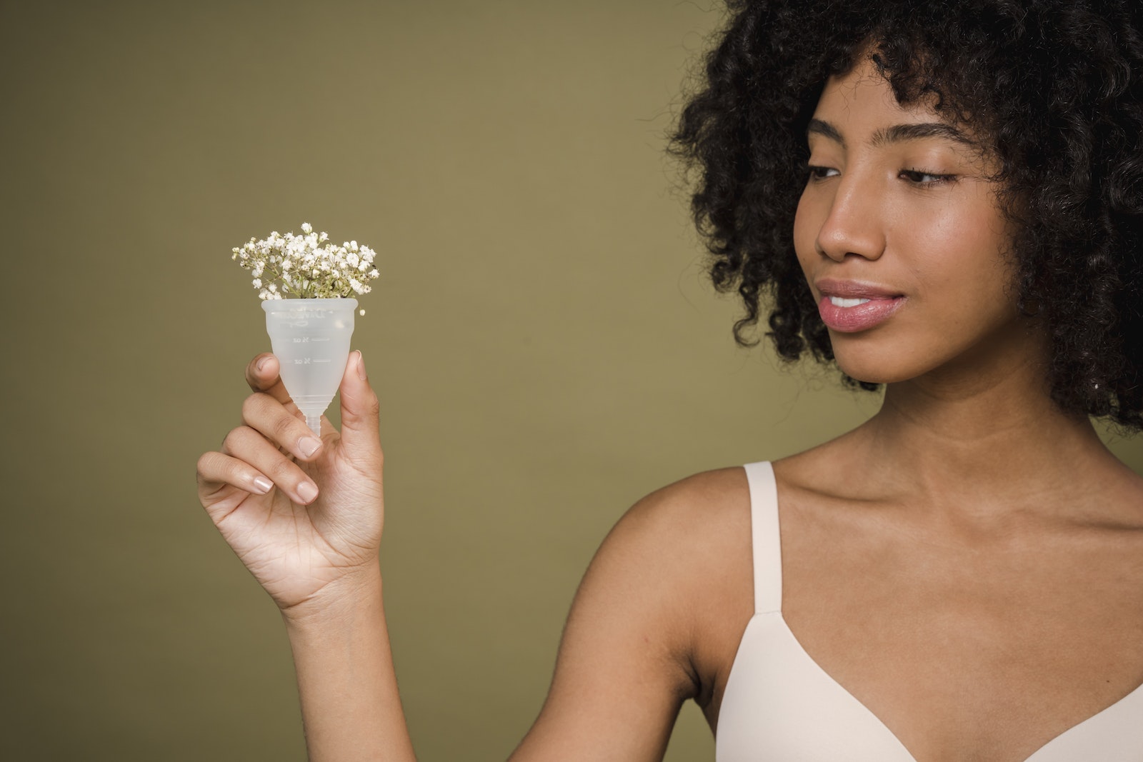 female showing menstrual cup