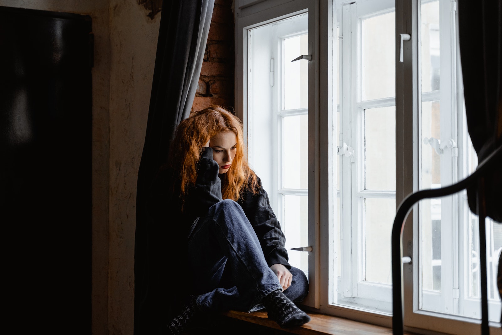 Woman Sitting on Brown Wooden Floor