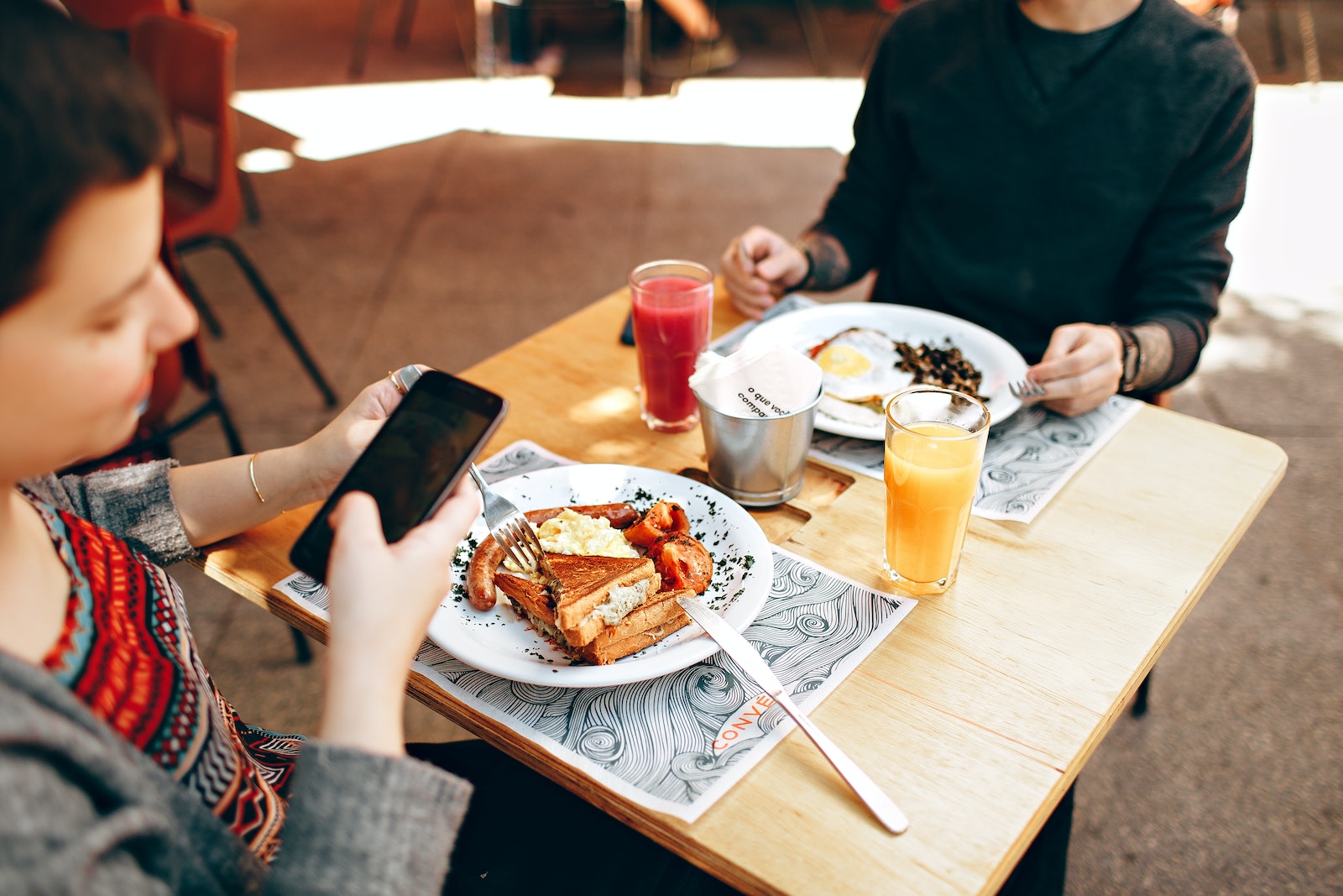 Two Person Eating in Wooden Bar Table